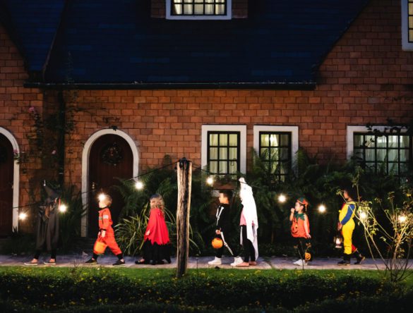 Children going to houses for candy on halloween